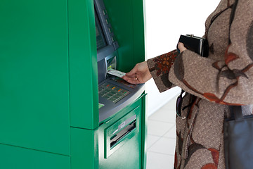 Image showing Girl uses bank terminal