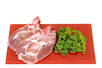 Image showing Pork chops on red plate