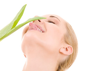 Image showing happy woman with green leaf