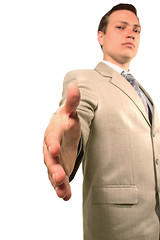 Image showing Serious businessman offering for a handshake