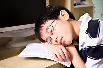Image showing Sleeping young student