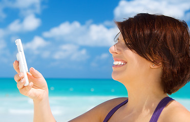 Image showing happy woman with phone on the beach