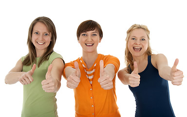 Image showing Three happy young women giving thumbs up
