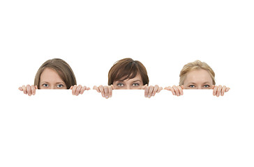 Image showing Three young women behind a blank banner ad