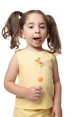 Image showing Little girl licking lips delicious