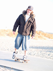 Image showing Cool modern skateboarder at the beach