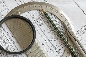 Image showing blueprint with pencil, steel protractor, compass and loupe