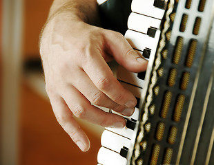 Image showing Musician hand playing accordion