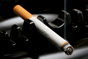 Image showing cigarette smoking in ashtray