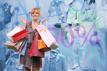 Image showing happy young girl with colored bags