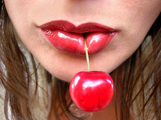 Image showing Red cherry in red lips