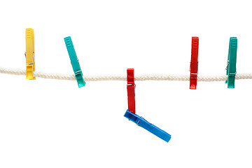 Image showing Colour clothes-pegs hung on linen rope