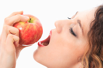 Image showing woman eating a red apple.