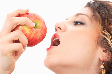 Image showing woman eating a red apple.