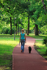 Image showing girl and her dog walking