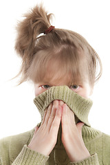 Image showing Girl hiding face with hands and sweater collar