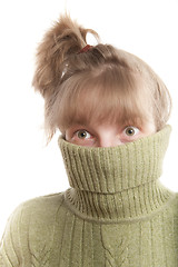 Image showing Young woman hinding face behind collar of her sweater