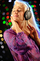 Image showing Beautiful woman listen music