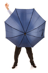 Image showing hiding bewind an umbrella