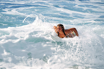 Image showing Hawaii, Kauai - Oct 21, 2008: Surfer girl Malia Rimavicus comes back ashore after training amidst the foamy shorebreaks