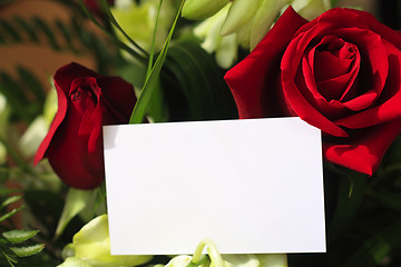 Image showing Red roses, orchids and a blank card
