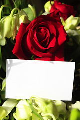 Image showing Red roses, orchids and a blank card