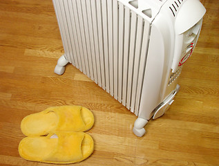 Image showing Oil heater and plush slippers