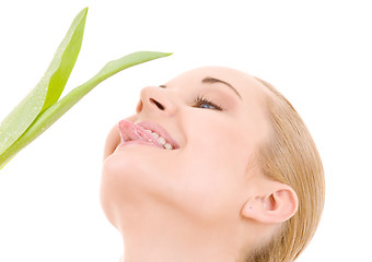 Image showing happy woman with green leaf