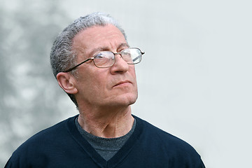 Image showing A senior man looking up