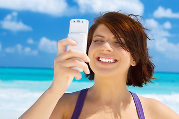 Image showing happy woman with phone on the beach