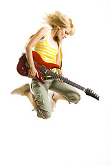 Image showing headbanging woman guitarist playing her guitar