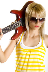 Image showing portrait of an attractive woman guitarist making a rock sign