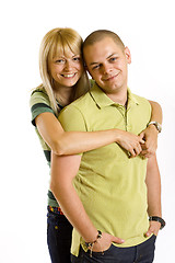 Image showing young man holding his girlfriend in the air