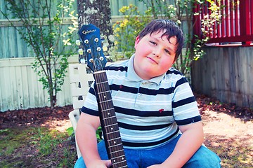 Image showing Young boy with a guitar