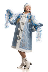 Image showing Happy girl in snow maiden fur coat with tinsel