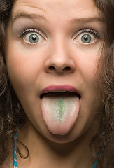 Image showing funny woman with green tongue