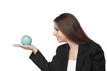 Image showing Business woman looking at the earth in her hand