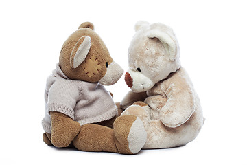 Image showing Two Teddy bears looking each other over white