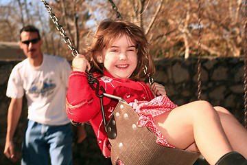 Image showing Father and Daughter Swinging on the Park