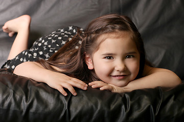 Image showing Beautiful Young Child Smiling Lying on a Couch