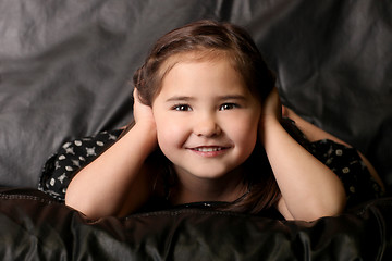 Image showing Cute Young Child Covering Her Ears