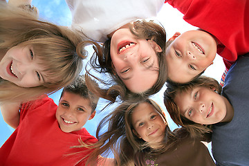 Image showing Happy Kids Huddling and Looking Down