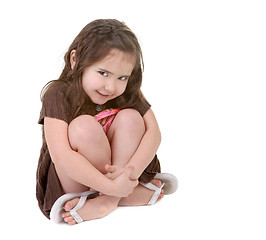 Image showing Expressive Young Child Hugging Her Legs