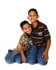 Image showing Hispanic Brothers Smiling and Hugging