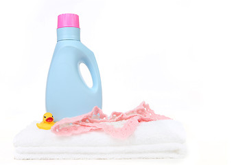 Image showing Baby Girl Laundry Items With Bottle of Detergent