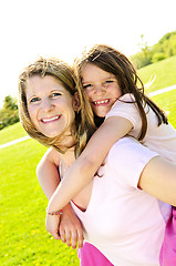 Image showing Mother and daughter piggyback