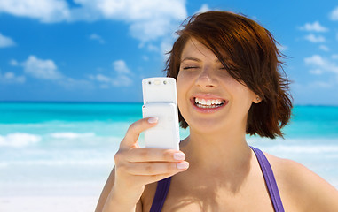 Image showing happy woman with phone on the beach