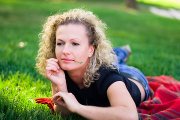 Image showing woman lying on green grass