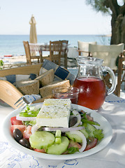 Image showing home made rose wine with greek salad and crusty bread at greek i