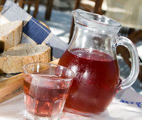 Image showing home made rose wine and crusty bread at greek island taverna